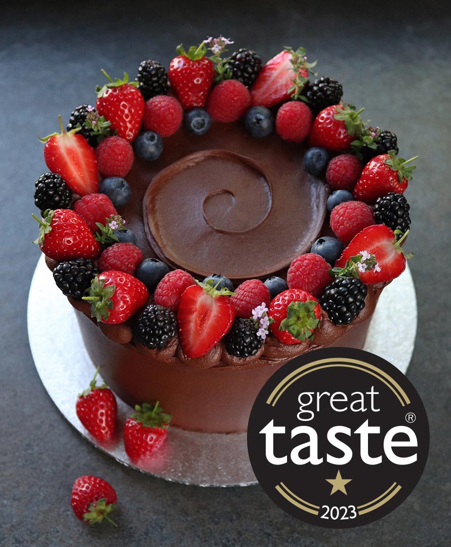 A deliciously damp gluten free, dairy free chocolate cake. Two layers, filled and frosted with dairy-free choc fudge buttercream. Made with organic ingredients, including Fairtrade cocoa powder, extra-virgin olive oil, ground almonds and Madagascar vanilla. All ingredients gluten-free and dairy-free