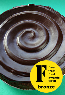 Glutenfree, sugarfree, dairyfree, flourfree Chocolate & Almond Cake, awarded bronze at the FreeFrom Food Awards 2018. Topped with sugarfree dark chocolate ganache.