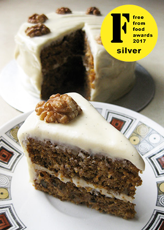 Award winning Gluten free vegan carrot cake. Made with organic carrot and coconut, crushed pineapple and chopped walnuts, and spiced with cinnamon, Jamaica allspice, ginger and Madagascar vanilla seeds. With vanilla seed & dairyfree cream cheese frosting. All ingredients glutenfree, eggfree and dairyfree, no animal products