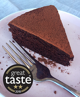 This deliciously damp gluten free, dairy free chocolate cake was awarded 2 stars at this year's Great Taste awards. Made with organic ingredients, including Fairtrade cocoa powder, extra-virgin olive oil, ground almonds and Madagascar vanilla, it keeps well and improves with age. All ingredients gluten-free and dairy-free