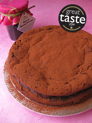 Award-winning chocolate truffle cake made with gluten free, dairy free ingredients: organic dark chocolate, organic extra-virgin olive oil, my own Spiced Boozy Prunes and <em>Kingston 62</em> Jamaica rum. All ingredients gluten-free and dairy-free. This cake won a Great Taste star in 2014