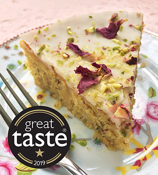 Awarded a Great Taste star – a moist, aromatic Lemon and Pistachio Cake. Made with gluten free, wheat free ingredients. Decorated here with fragrant organic rose petals. Delivery or collection in London, can be posted. All ingredients glutenfree