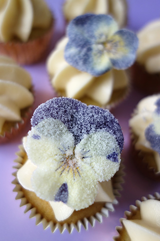 Gluten-free Lemon & Lavender mini cupcakes, made with organic ingredients. Topped with a swirl of buttercream and sugared pansies. All ingredients gluten free. Delivered by hand in London
