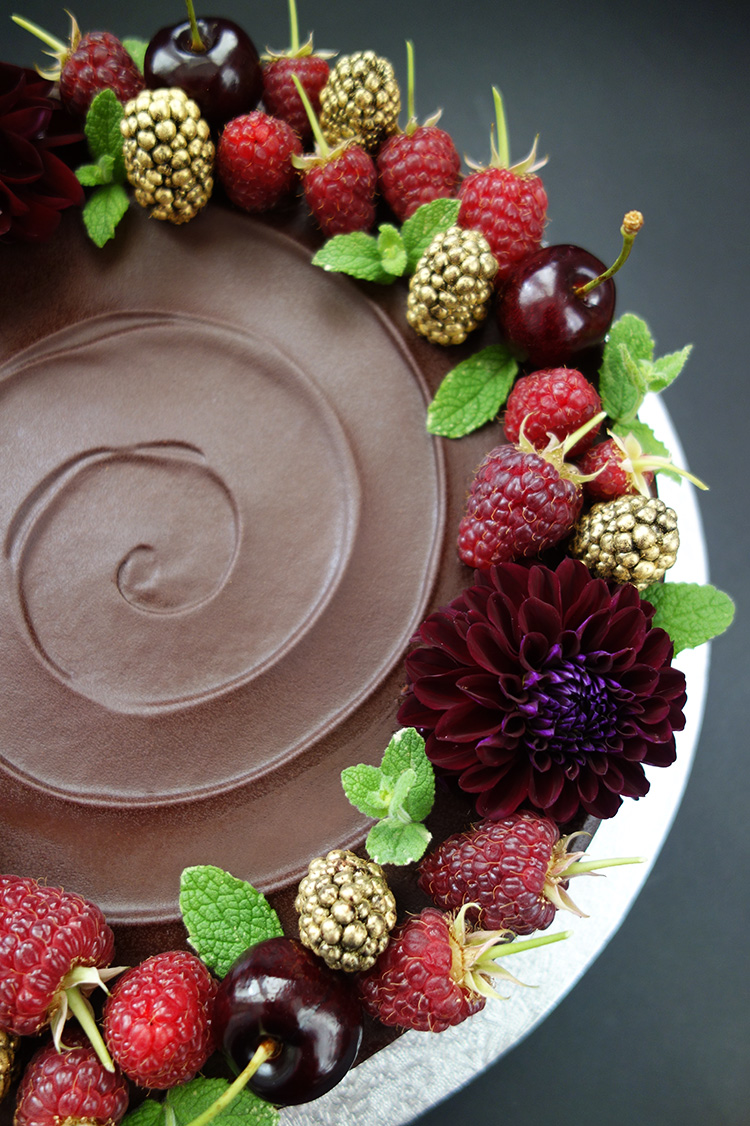 Gluten-free, dairy-free, sugar-free chocolate and almond cake made with organic Fairtrade chocolate, organic ground almonds and Appleton Jamaica Rum, with a dash of almond essence. Covered in sugar-free chocolate ganache and decorated with fresh berries, cherries and organic edible flowers