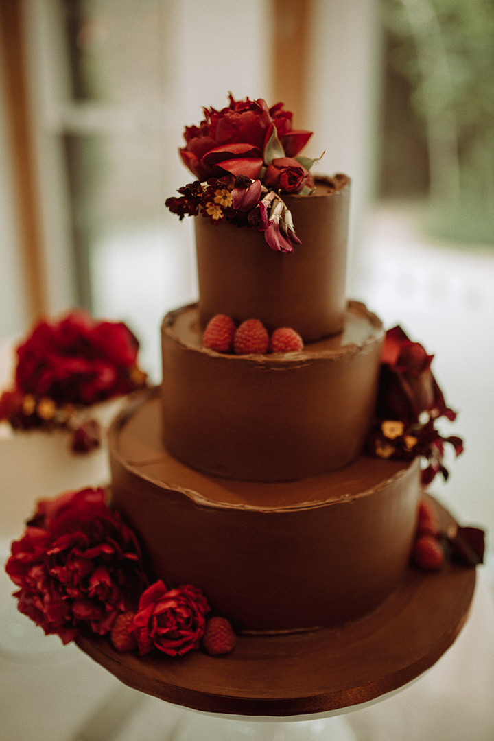A three-tier chocolate cake for a May wedding at the Museum of the Home. Gluten-free and wheat-free. Two tiers of award-winning Reine de Saba (chocolate, rum & almond), filled with dark ganache. And one of award-winning chocolate & olive oil cake, filled with choc fudge buttercream. All cakes covered with organic dark ganache. All ingredients gluten free. Price includes delivery and assembly at your London venue. Decorated with berries, and organic edible flowers from Aweside Farm